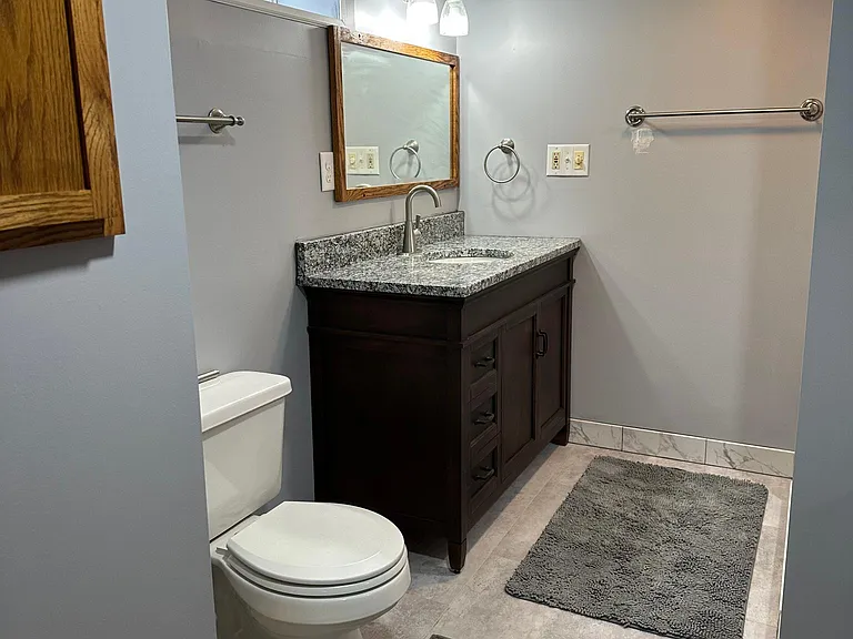 New solid wood vanity with granite countertop and new faucet