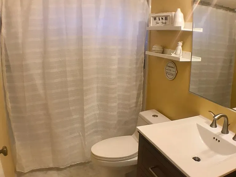 Bathroom with marble floor and Moen faucets