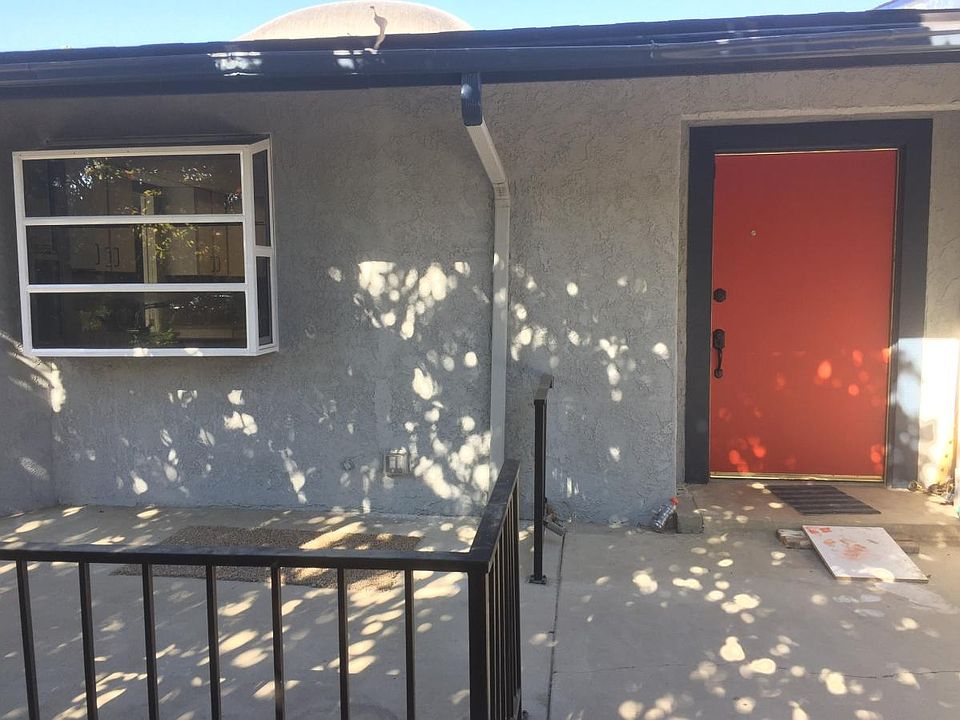 Front door with patio to left
