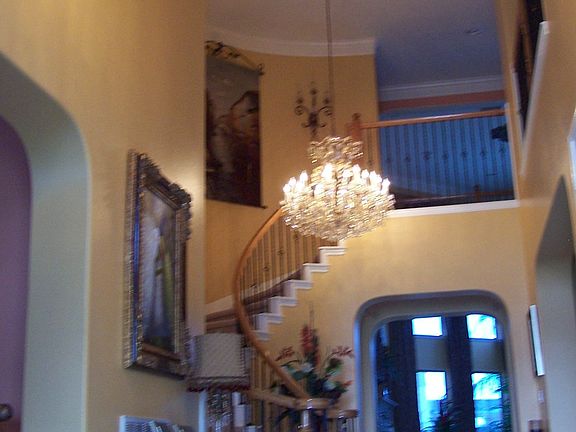 Impressive grand entrance with 20' high ceiling and elegant chandeliers.
