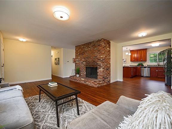 The sightline to the kitchen lends itself to conversation. Gleaming vinyl flooring underfoot provides a striking complimentary a