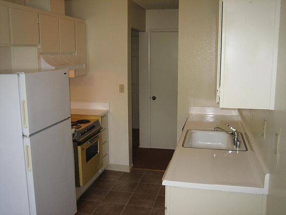 Modern kitchen with resurfaced counter tops, refrigerator, d