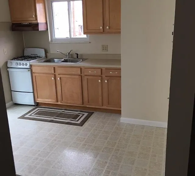 New Kitchen Cabinets along with new gas range and refrigerator.