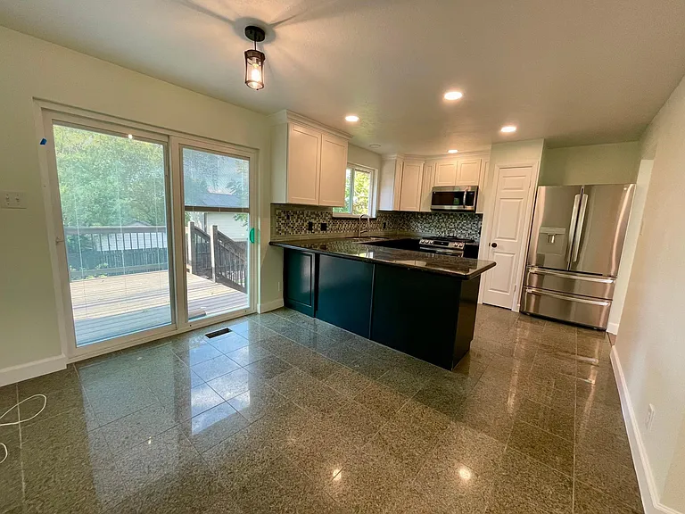 Upgraded appliances, granite countertop, pantry, full height cabinetry.