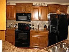 Custom Oak cabinet and Whirlpool appliances