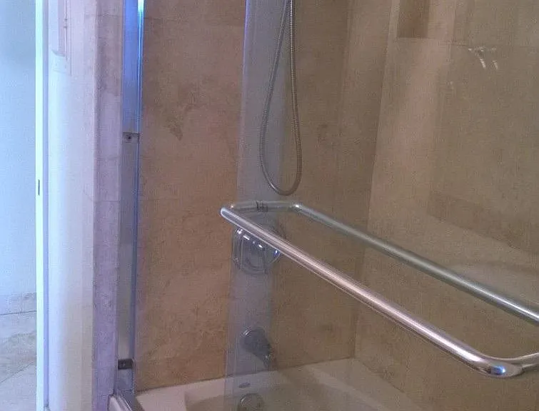 Shower - jacuzzi tub & travertine walls