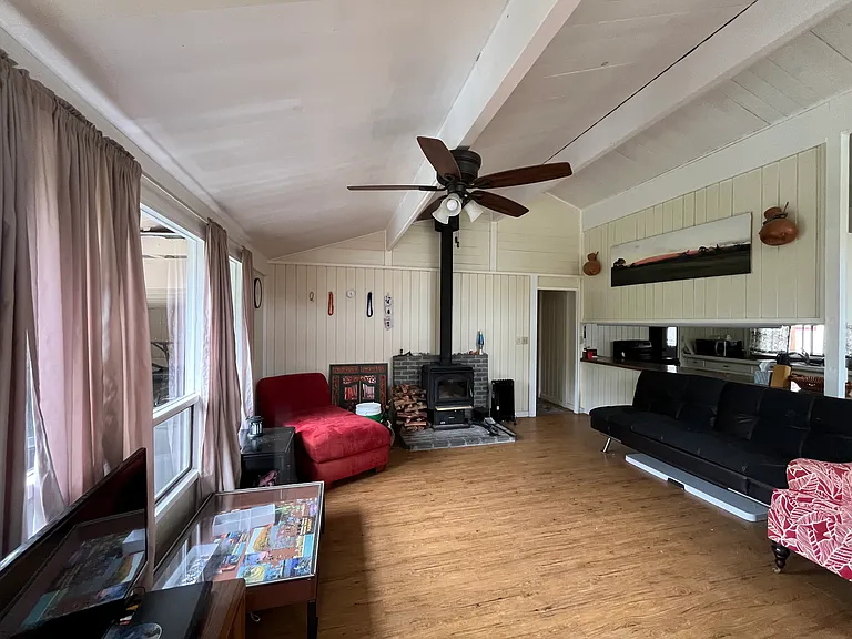 Bright, open living with fireplace. Read by the fire, do puzzles, or watch pheasants out the windows. Futon was replaced by cozy chairs with ottomans. TV with DVD player is not a smart TV. Wifi is included, compatible with laptops or smart TV, if added.