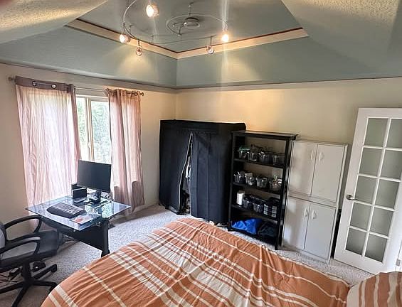 Bedroom has a double bed and desk/chair and storage units.