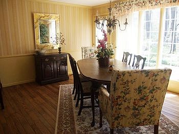 Beautiful dining room overlooks brick patio.