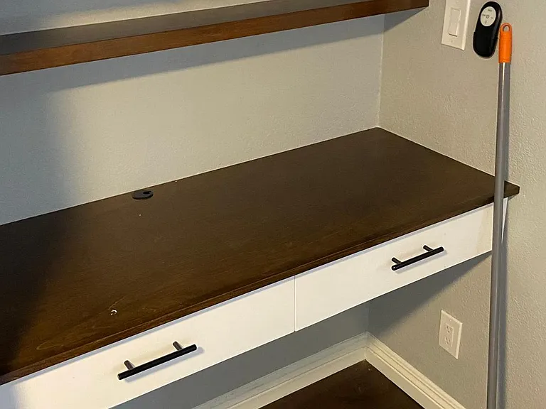 Small Bedroom next to kitchen with built in desk and extra shiner space