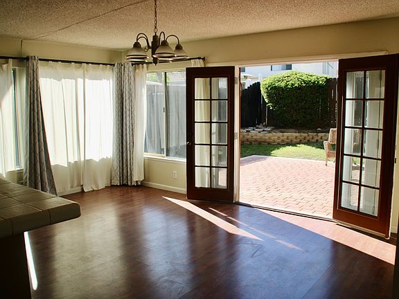 family room w/ French doors leading to backyard
