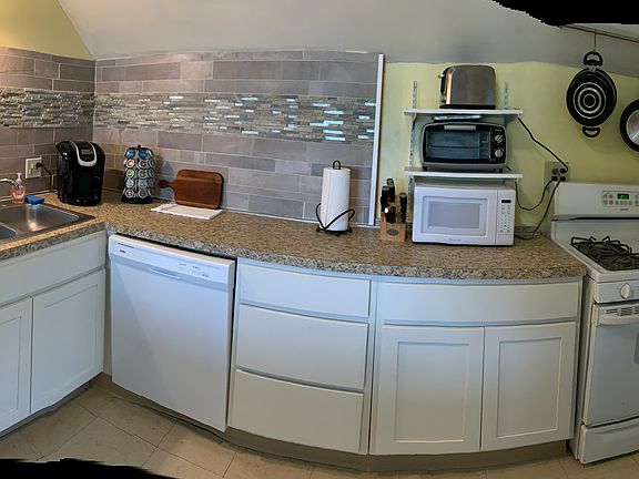 counter with stove and dishwasher