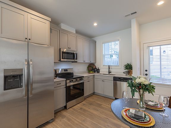 Full kitchen including an electric range, microwave, refrigerator (w/ ice machine), dishwasher and disposal