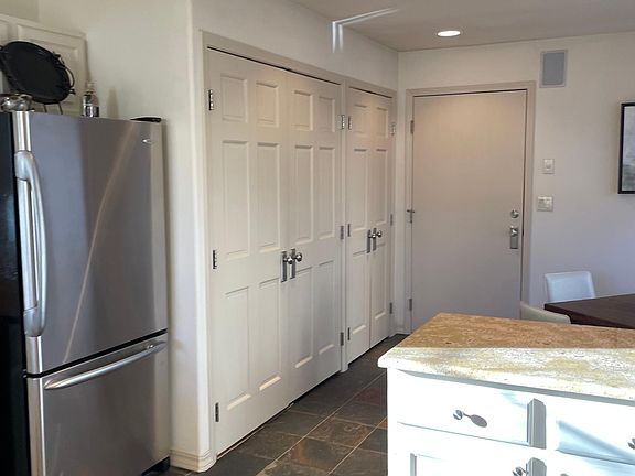 Washer/dryer and pantry area to the left behind closet doors. Entry to garage
