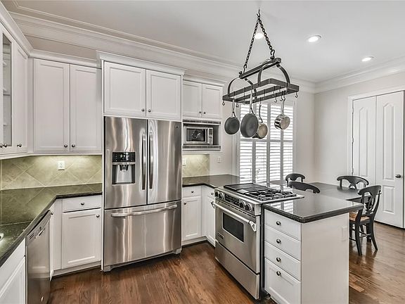 Another perspective of the kitchen overlooking the breakfast room with view of the pantry.