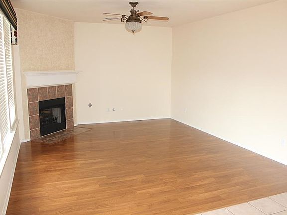 Family room with fireplace overlooks the backyard.