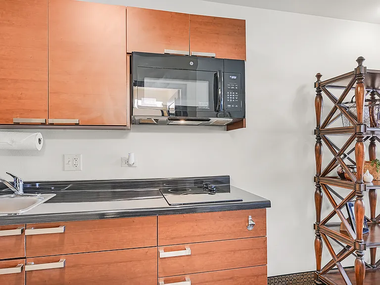 Kitchens include full sized fridge, cooktop range, and microwave.