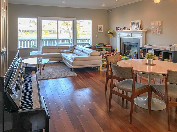 Living and dining area feature hardwood floor and recessed lights