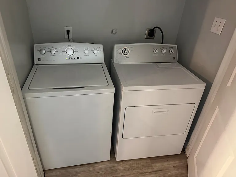 Dedicated laundry closet with full-size washer and dryer for convenient in-home wash days.