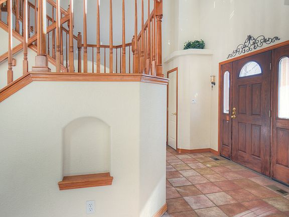 Front door entrance with the staircase to the upper level