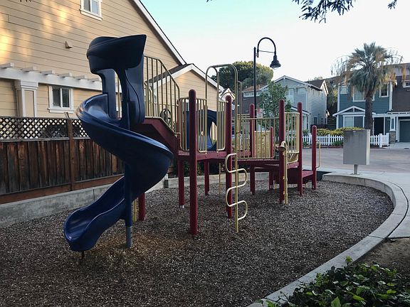 Community park with bench and playground.