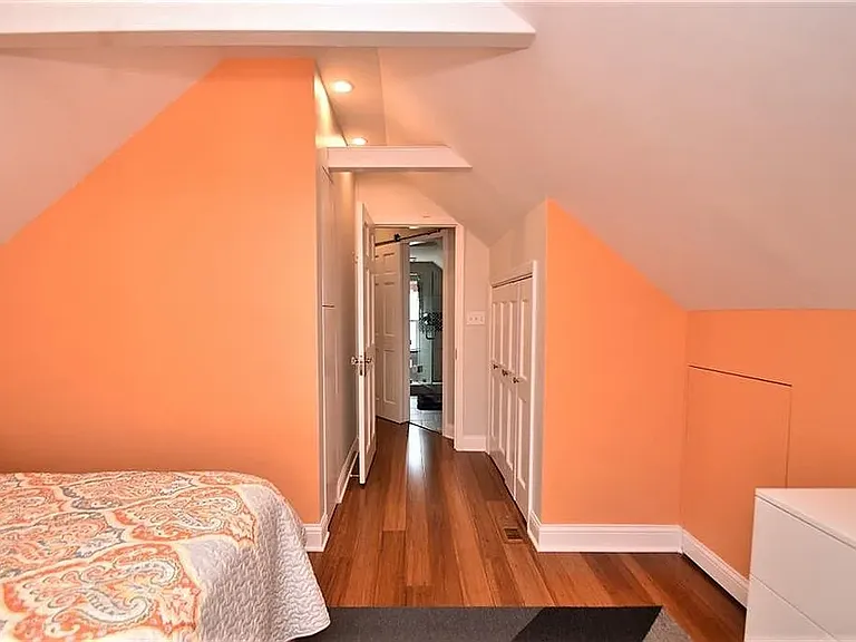 3rd floor bedroom looking into the hallway full bathroom and closets to the right and left