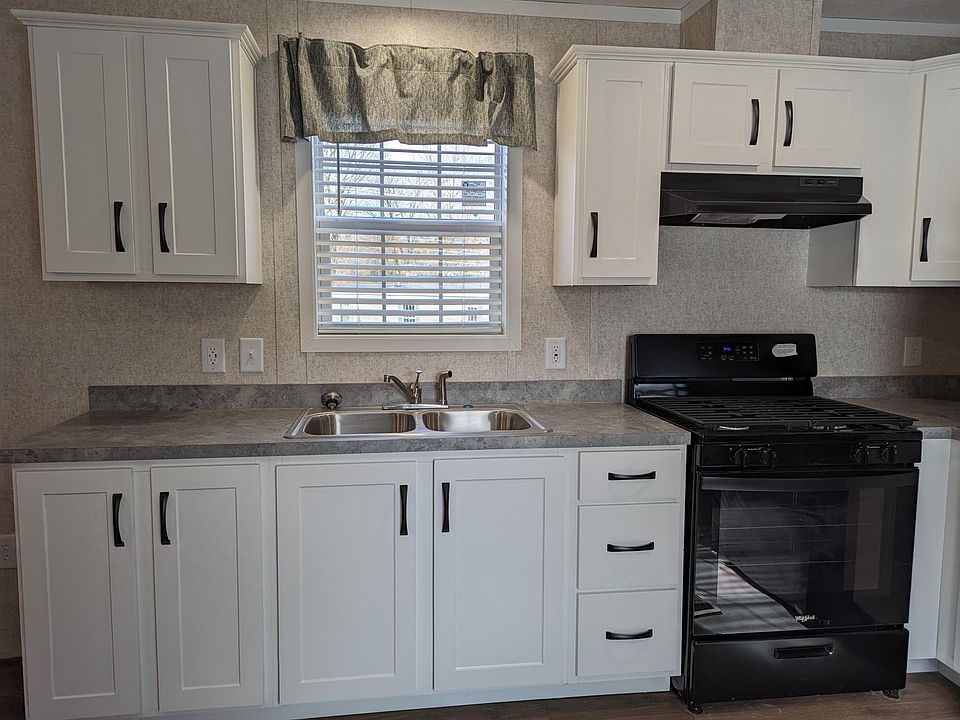 Sink with window and stove with exhaust to outside