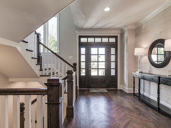 Glass doors anchor a light-filled arrival