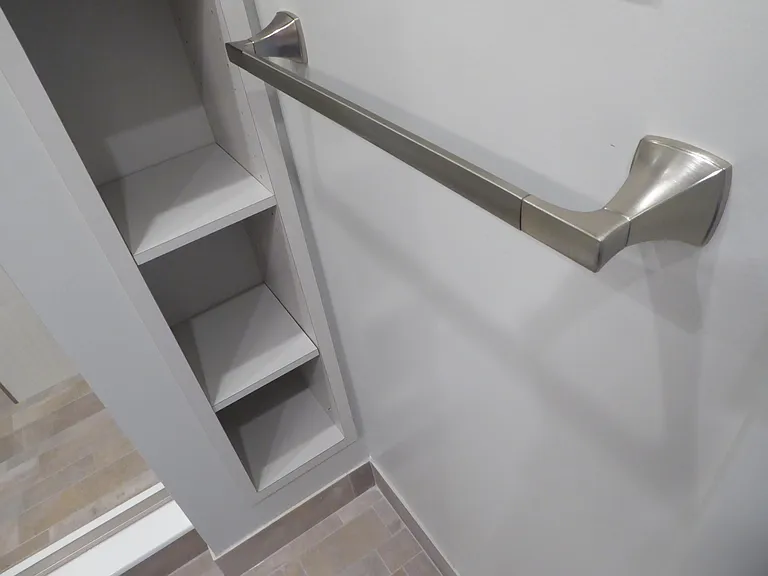 The apartment features stylish nickel accessories and plenty of built-ins.