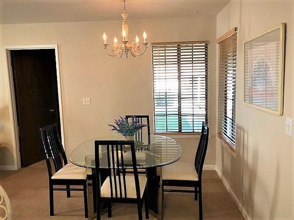 Nice dining nook with bright windows overlooking front porch area.