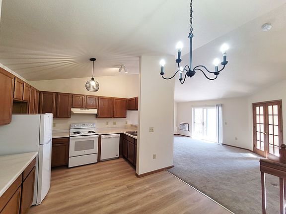 The kitchen and dining area have new lighting, new stove, and refrigerator too.