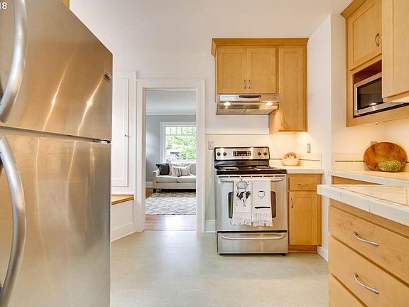 Cute kitchen with new countertops, flooring, and built in dining nook