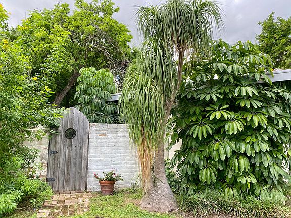 Front side yard with gate to backyard courtyard