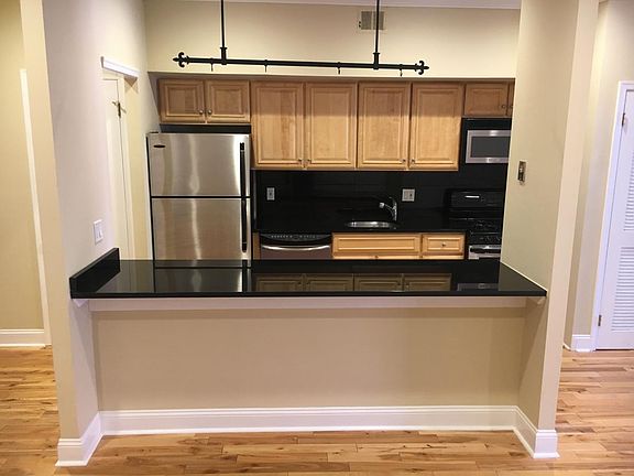 Well laid out kitchen with full complement of stainless appliances and granite tops