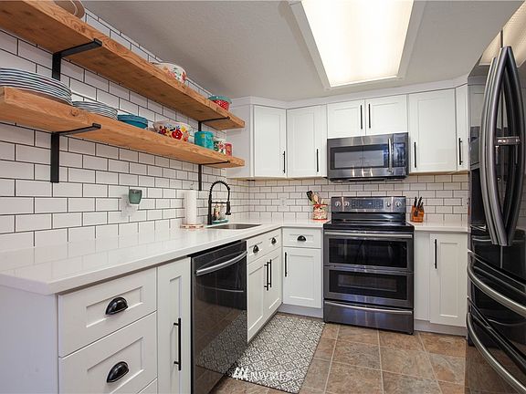 Remodeled kitchen has double oven, custom cabinets