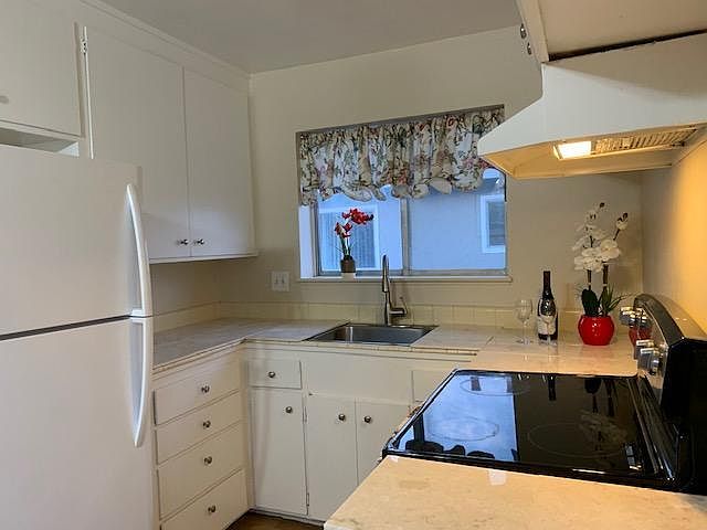 Kitchen with fresh paint; new floor; new faucet and garbage disposal/ One year old fridge and stainless steel stove/oven;New granite to be installed next Friday