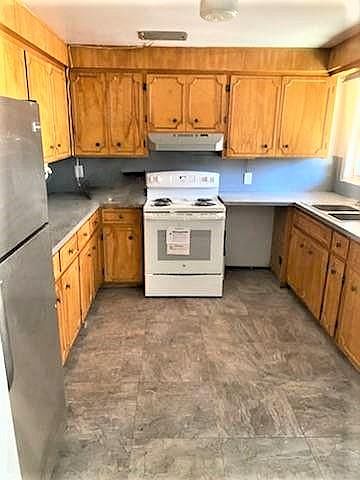 Kitchen with new electric range, newer refrigerator and lots of cabinets