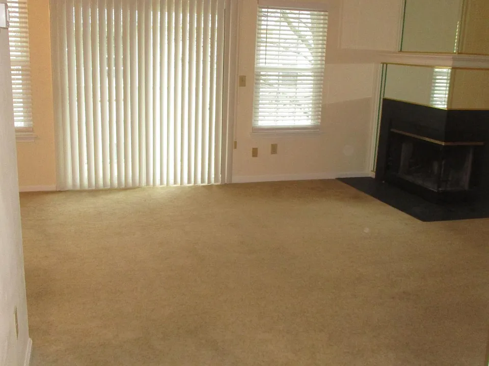 living room with wood burning fireplace and sliding glass door that leads out to balcony