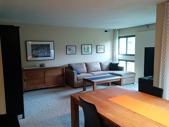 Open concept living room/dining room with view of Lake Anne.
