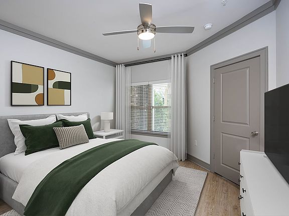 Bedroom with hard-surface vinyl plank flooring and ceiling fan