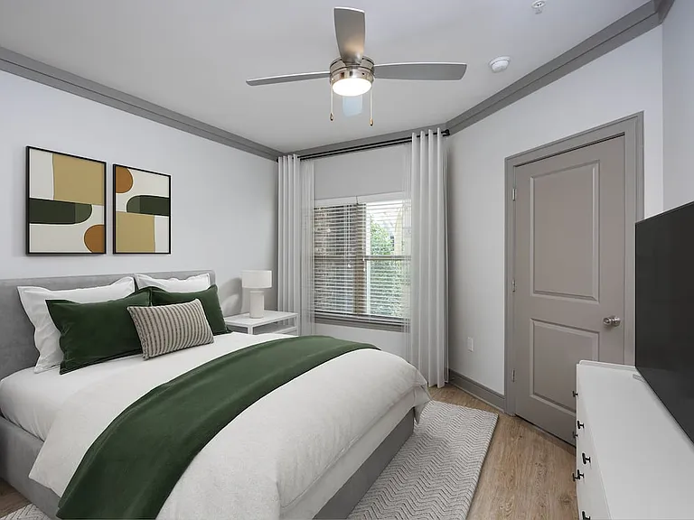Bedroom with hard-surface vinyl plank flooring and ceiling fan