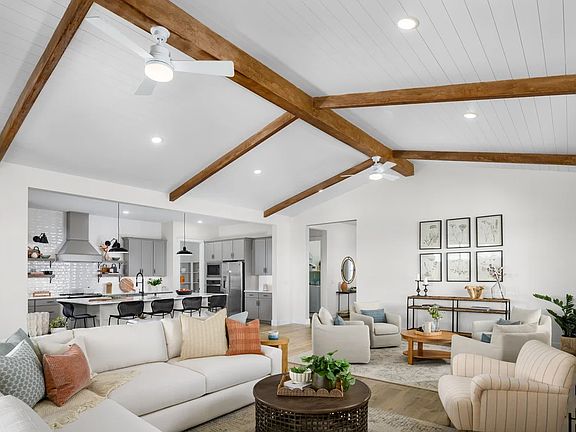Great room with vaulted ceiling and stained ceiling beams