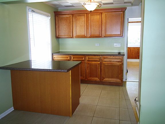 Rich Wood Cabinetry at Kitchen-End of Living Rm