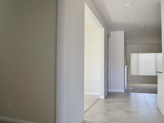Front Door opens to Entry with Den/Office and Formal Dining Area on your left