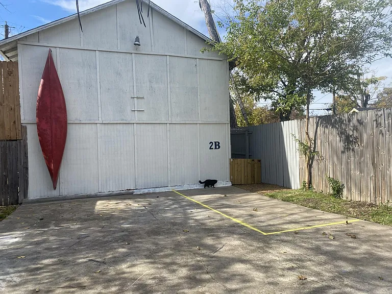 Entrance is just past the gate on the right. The yellow is the designated parking spot. Well lit at night with motion lights.