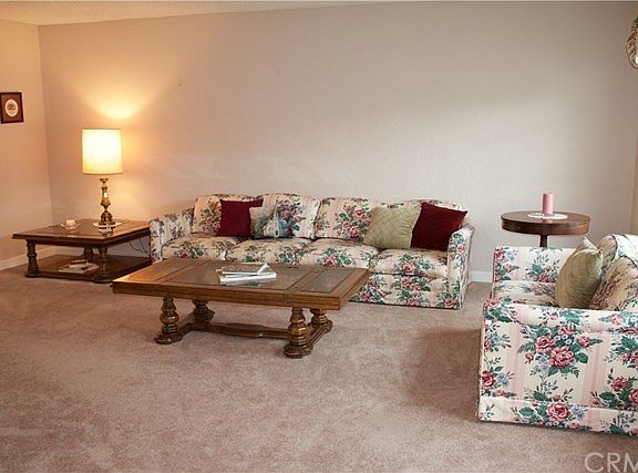 Gorgeous large living room with plush carpeting and neutral paint