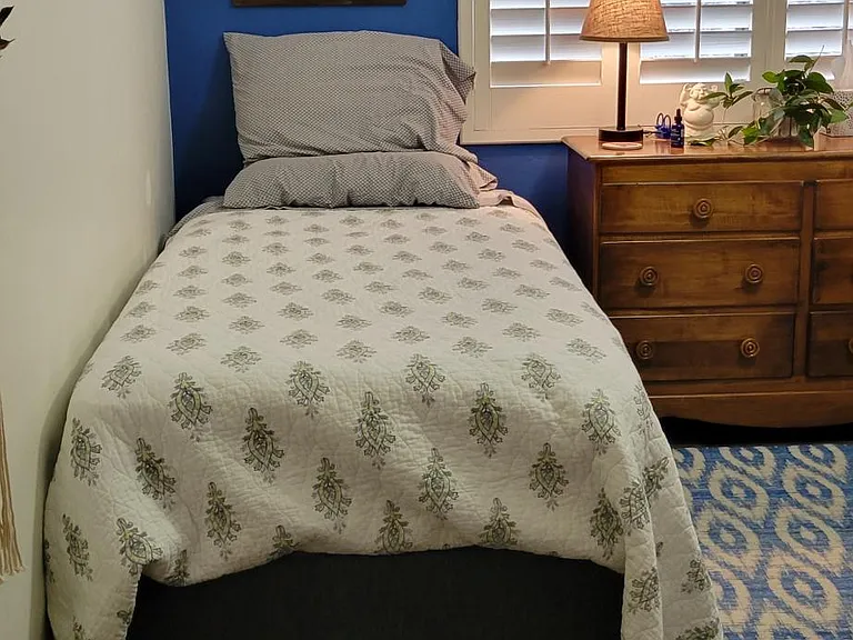 Extra long twin bed with new firm mattress.
