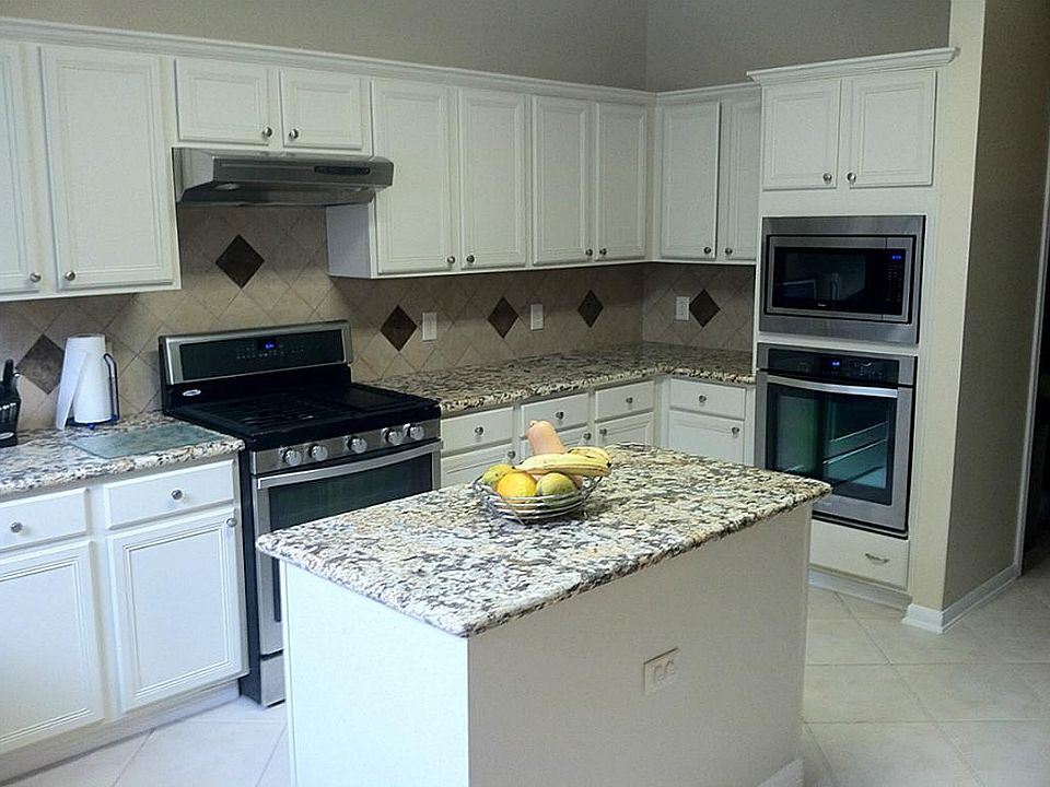 Recently updated kitchen with refinished cabinets, granite counters and tile back splash.