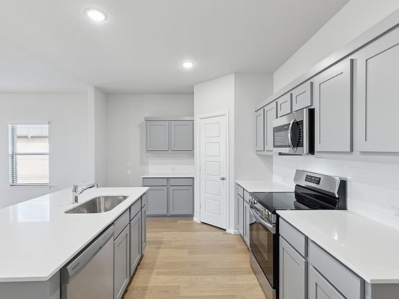 Kitchen in the Holden home plan by Trophy Signature Homes - REPRESENTATIVE PHOTO