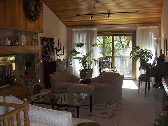 Main floor family room with stone fireplace and great views of the property
